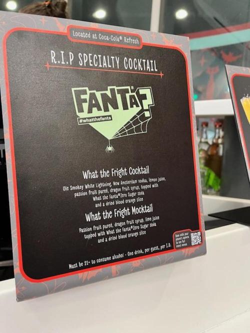 Sign for a specialty cocktail featuring Fanta, detailing ingredients and drink options, with a spooky theme.