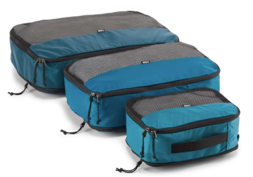 Three blue packing cubes of varying sizes with mesh tops, designed for organizing luggage.