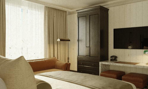 Cozy hotel room featuring a bed, wooden wardrobe, TV, and a desk with a lamp, illuminated by natural light.