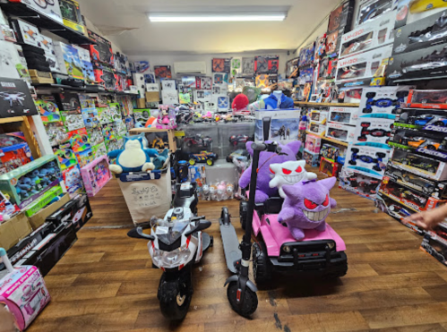 A toy store filled with various toys, including plush characters and scooters, in a colorful, cluttered display.