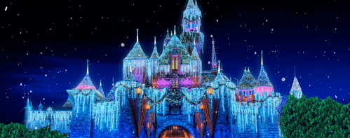 A beautifully illuminated castle at night, adorned with colorful lights and surrounded by a starry sky.