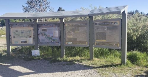 Information boards at a trailhead, featuring maps and details about the Continental Divide Trail.