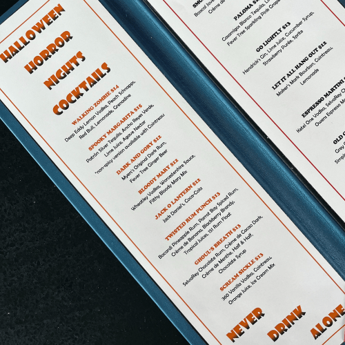 Menu featuring Halloween-themed cocktails with playful names and prices.