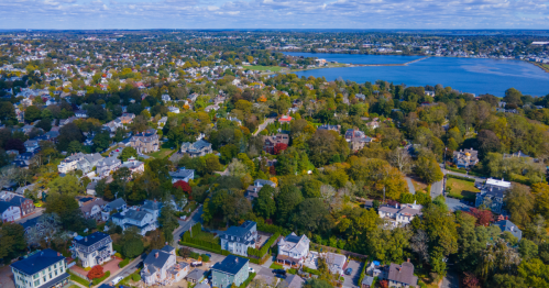 aerial shot of middletown with trees and houses and its coast during fall in rhode island