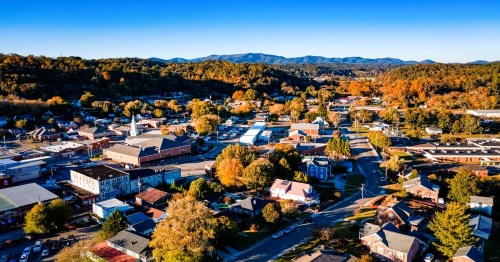 Aerial view of Ellijay, a small town in Georgia, surrounded by mountains with colorful autumn foliage.