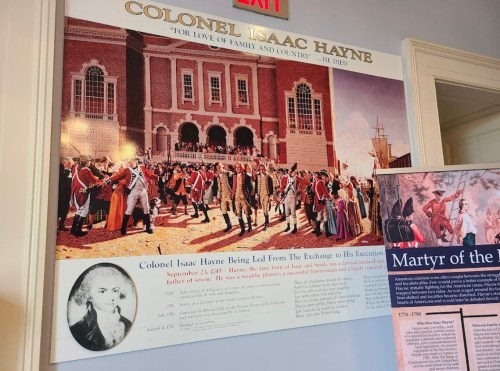 Historical mural depicting Colonel Isaac Hayne's execution, with soldiers and a crowd in a colonial setting.