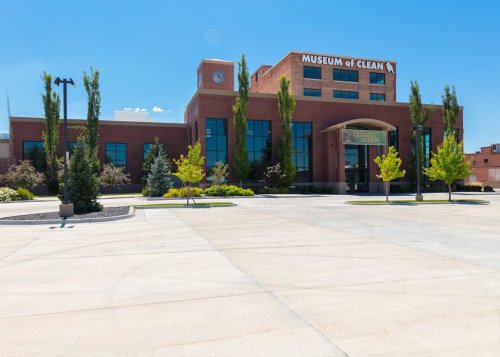 Exterior view of the Museum of Clean, featuring a modern building with trees and a clear blue sky.