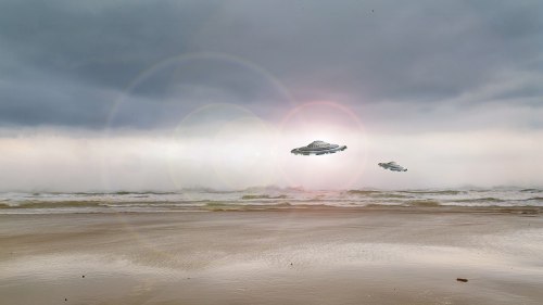 Two futuristic flying saucers hover above a beach under a cloudy sky, with waves gently lapping at the shore.