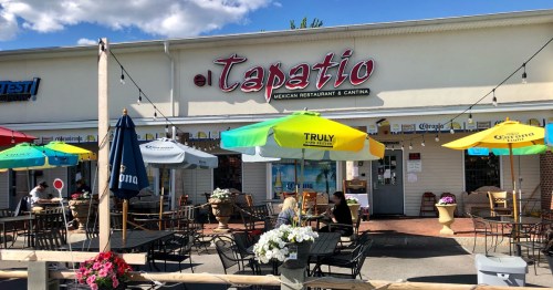 Exterior of El Tapatio Mexican Restaurant with outdoor seating and colorful umbrellas on a sunny day.