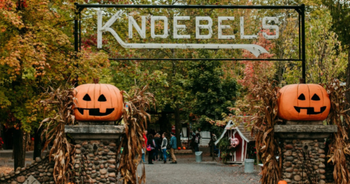 Entrance to Knoebels amusement park, decorated with pumpkins and autumn foliage.