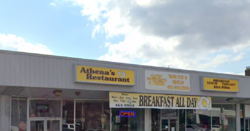 Exterior of Athena's Restaurant with a bright "OPEN" sign and a "BREAKFAST ALL DAY" banner. Cloudy sky above.