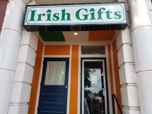 Storefront of "Irish Gifts" featuring a colorful exterior with green and orange accents.