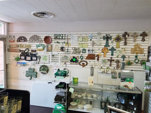 A display wall in a shop featuring various Irish-themed decorations, including crosses and shamrocks.
