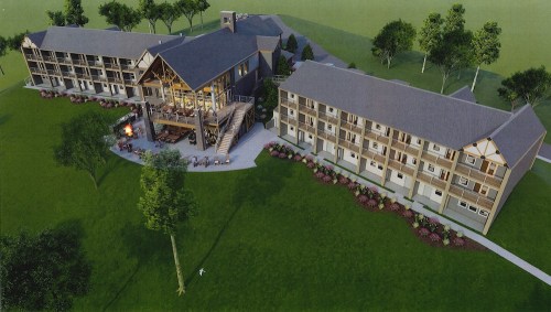 Aerial view of a modern lodge with multiple buildings surrounded by green lawns and landscaped gardens.