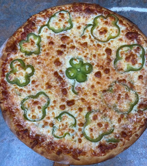 A cheese pizza topped with green bell pepper slices arranged in a circular pattern.
