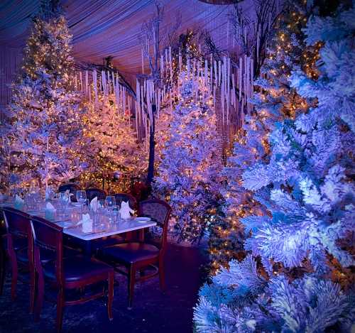 A cozy dining area surrounded by frosted Christmas trees and twinkling lights, creating a festive atmosphere.