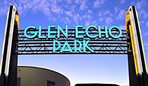 Neon sign for Glen Echo Park against a twilight sky, featuring bold blue and yellow lettering.