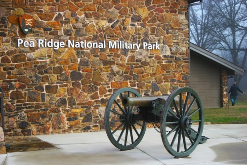 A cannon on display in front of the stone building at Pea Ridge National Military Park.