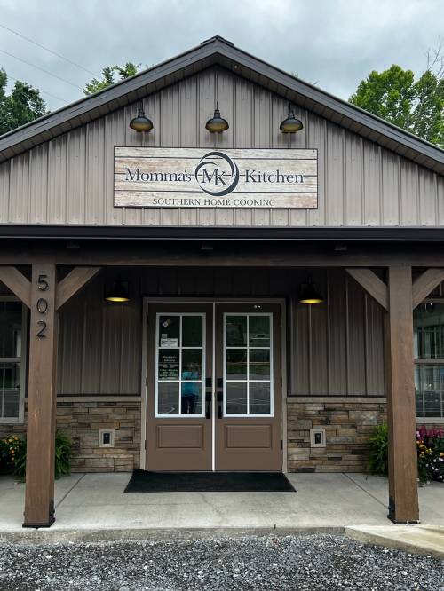 Exterior of Momma's Kitchen, a Southern home cooking restaurant, featuring a welcoming entrance and rustic signage.