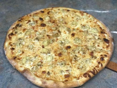 A freshly baked pizza with a golden crust, topped with cheese and pieces of artichoke, sliced into wedges.