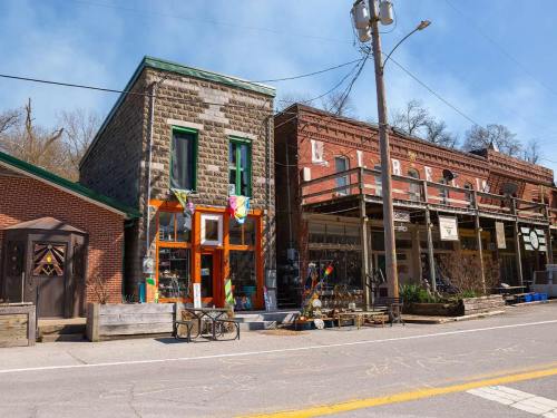A quaint street scene featuring historic stone and brick buildings with colorful decorations and outdoor displays.