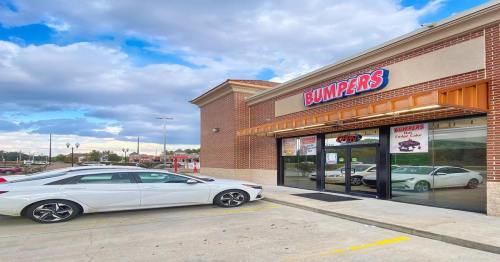 Exterior of a Bumpers store with a white car parked outside, under a cloudy sky.