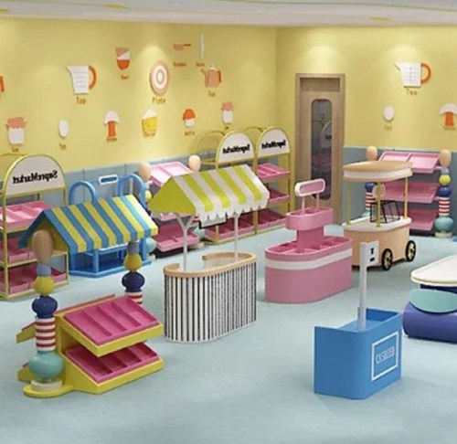 Colorful playroom with various market stalls and carts, featuring bright decorations and a playful atmosphere.