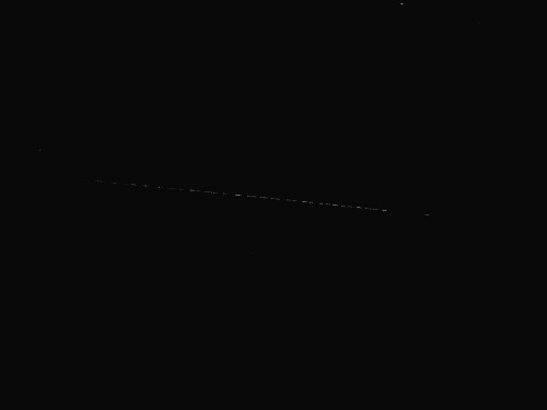 A dark image with a faint, horizontal line across the center, suggesting minimal light or detail.
