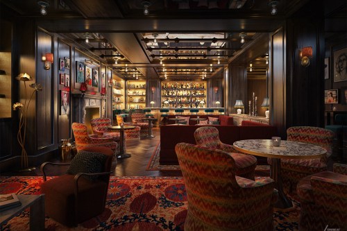 Cozy lounge with patterned chairs, a bar lined with bottles, and warm lighting, creating an inviting atmosphere.