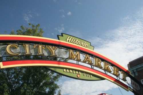 Sign for Historic City Market in Kansas City, featuring colorful lettering against a blue sky.