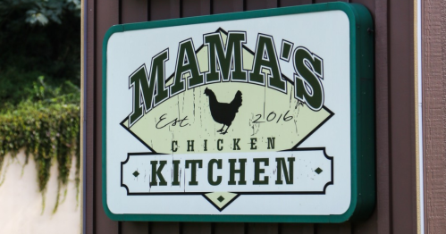 Sign for "Mama's Chicken Kitchen," established in 2016, featuring a chicken graphic.