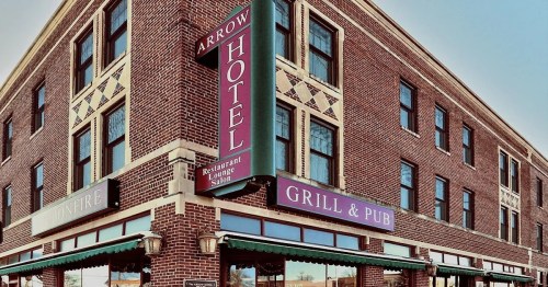 Exterior view of the Arrow Hotel featuring a restaurant and pub, with brick architecture and large windows.