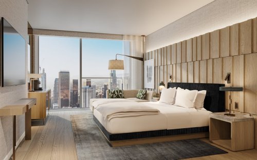 Modern hotel room with a large window showcasing a city view, featuring a king-sized bed and stylish decor.