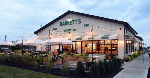 Exterior of Barrett's Cafe Bakery Co., featuring outdoor seating, string lights, and a welcoming atmosphere.