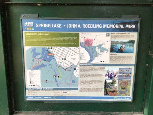 Information sign for Abbott Marshlands, detailing Spring Lake and John A. Roebling Memorial Park features and trails.