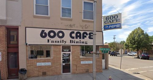 Exterior of 600 Cafe, a family dining restaurant, featuring a sign and nearby street corner.