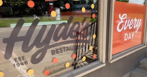 Window display of Hyde's Restaurant, established in 1946, featuring colorful dots and a sign that says "Every Day."