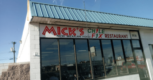 Sign for Mick's Chile Fix Restaurant, featuring "New Mexican Food" in bold letters, with a blue roof and large windows.