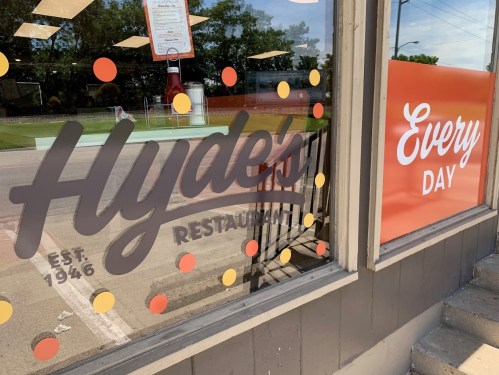 Window display of Hyde's Restaurant featuring colorful dots and a sign that reads "Every Day." Established 1946.