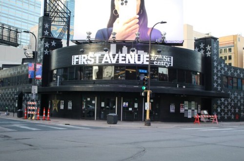 Exterior of First Avenue music venue, featuring a large star-patterned facade and a prominent billboard.
