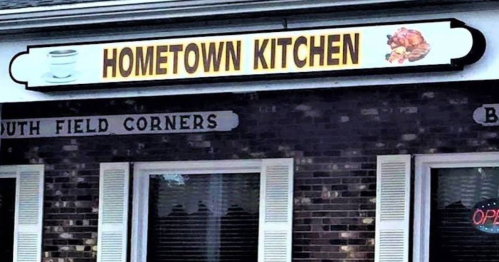 Sign for "Hometown Kitchen" with a graphic of a turkey, located at South Field Corners. Open sign visible.