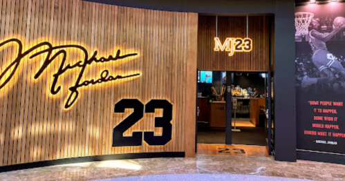 Entrance to a Michael Jordan-themed space featuring his signature and the number 23 on a wooden wall.