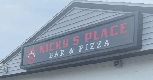 Sign for "Nicky's Place Bar & Pizza" featuring bold red lettering on a black background.