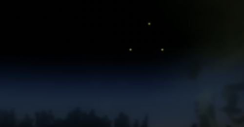 Three bright lights in a dark night sky above a silhouette of trees.