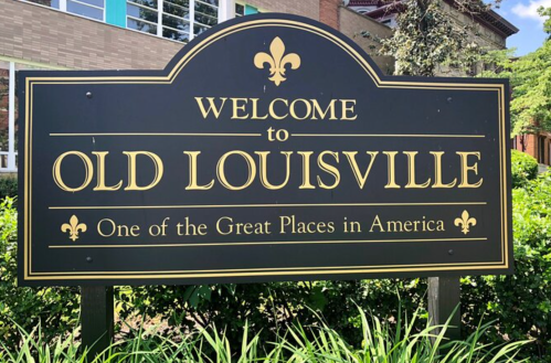 A sign welcoming visitors to Old Louisville, highlighting it as one of the Great Places in America.