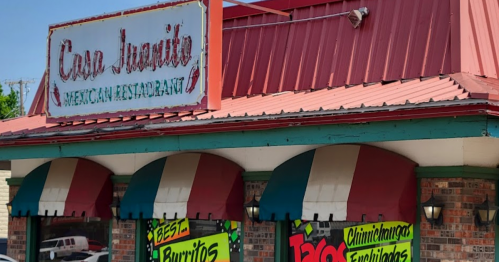 Exterior of Casa Juarez Mexican Restaurant, featuring colorful awnings and vibrant signage highlighting menu items.