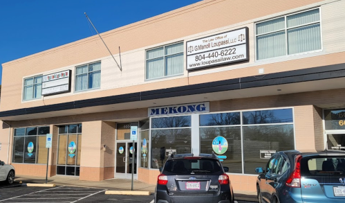 Exterior of a building with a sign for "The Law Office of G. Manuel Loupass, LLC" and a restaurant named "MEKONG."