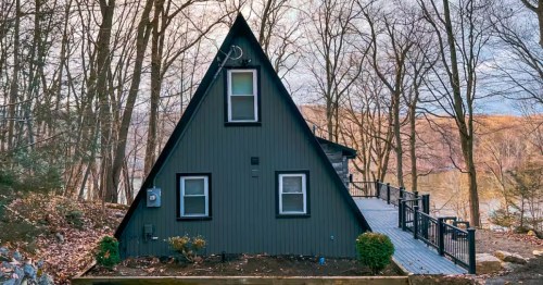 Dark A-frame cabin on the lake in New Jersey.