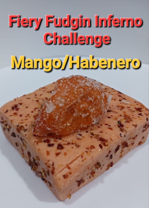 A square dessert labeled "Fiery Fudgin Inferno Challenge" with mango and habanero, topped with a candied pepper.