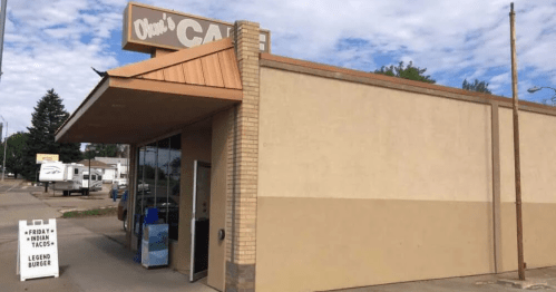 exterior of the beige-colored exterior and sign of ohm's cafe located in mandan north dakota